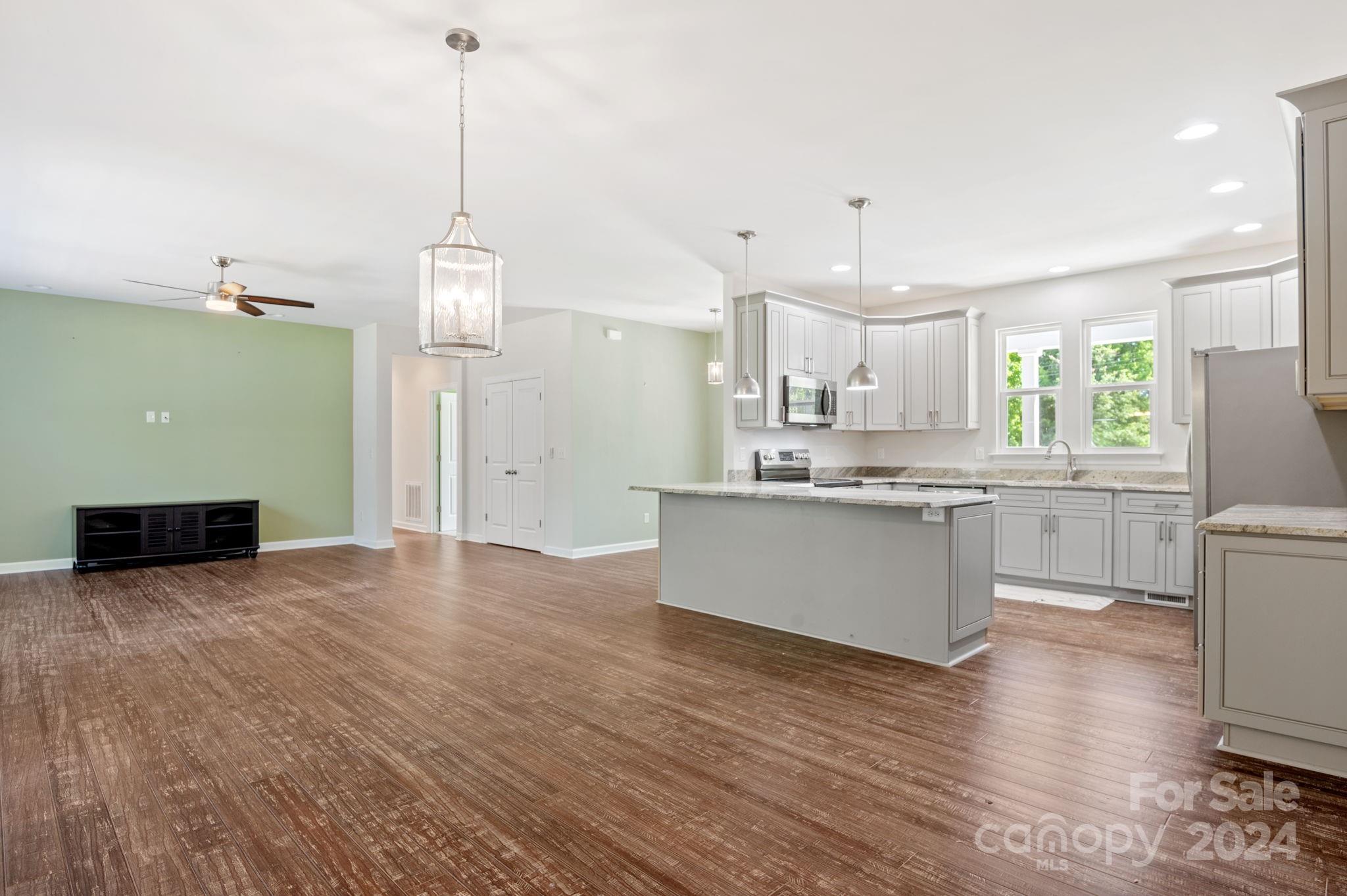 4655 Old Hickory Road Lancaster, SC 29720 - Photo 11 of 35 a large kitchen with granite countertop a white stove top oven and cabinets