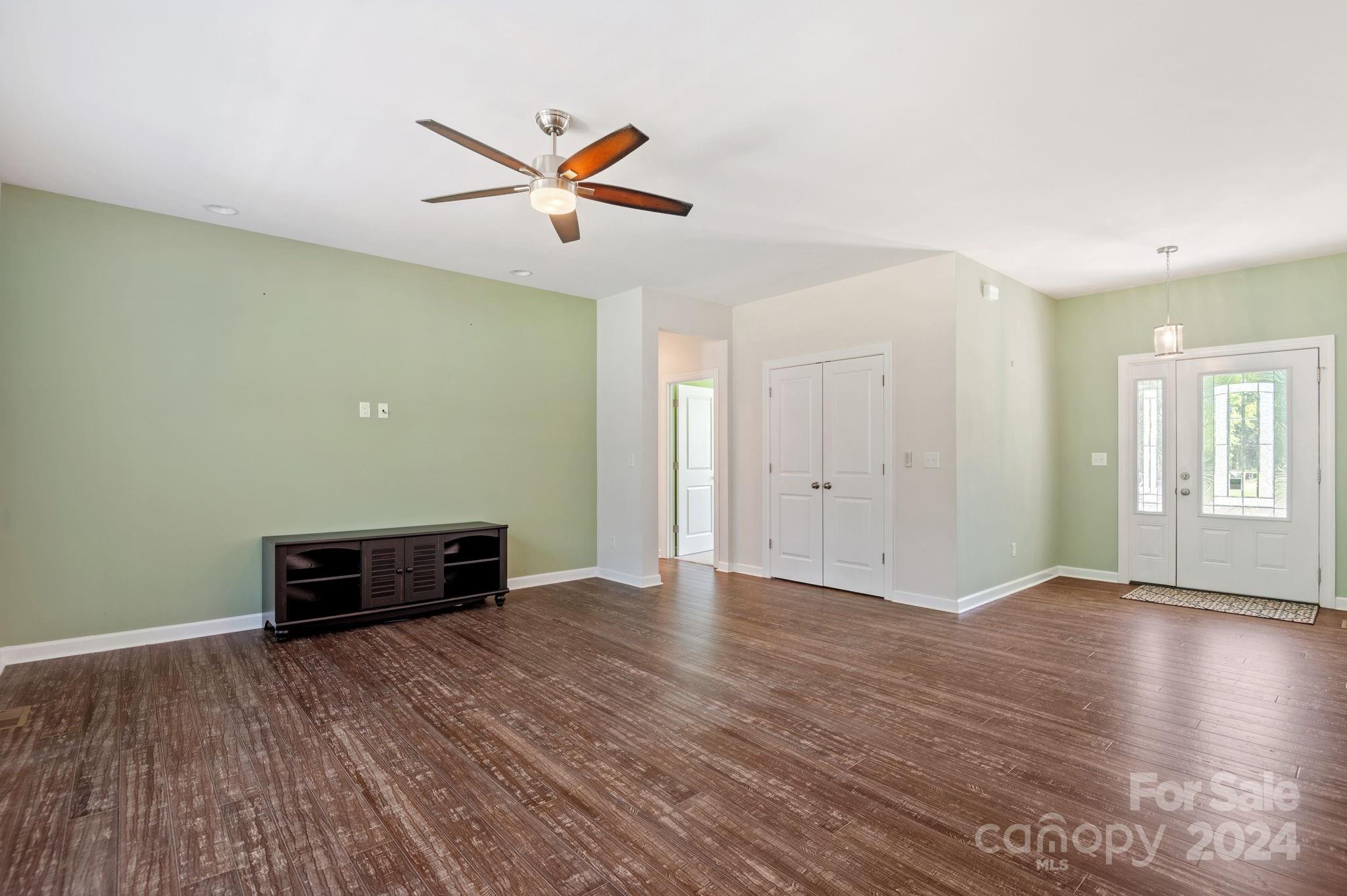 4655 Old Hickory Road Lancaster, SC 29720 - Photo 15 of 35 an empty room with wooden floor a ceiling fan and windows