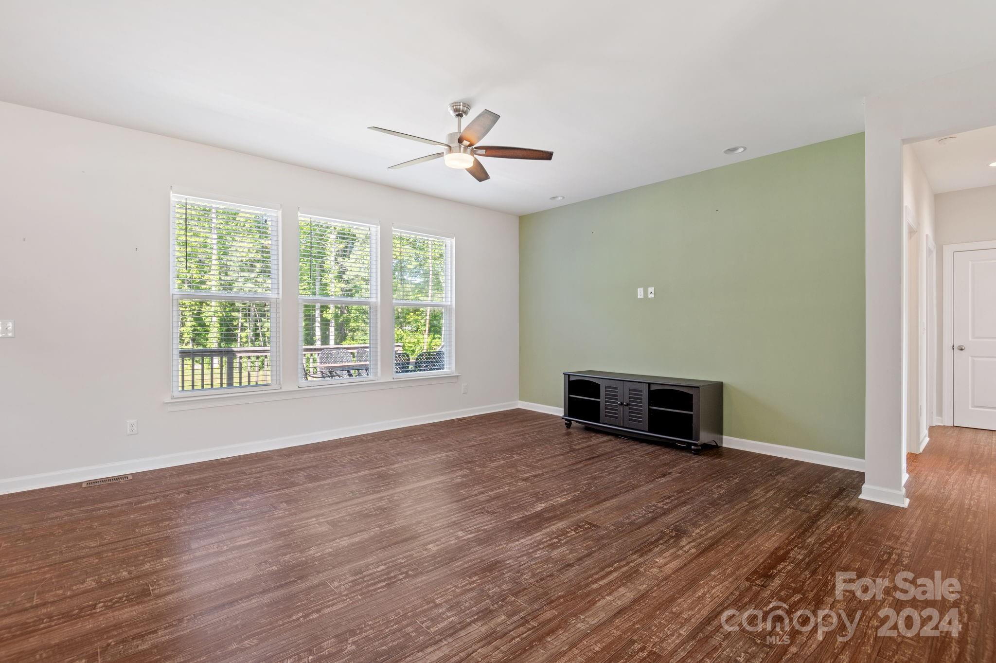 4655 Old Hickory Road Lancaster, SC 29720 - Photo 16 of 35 an empty room with wooden floor chandelier fan and windows