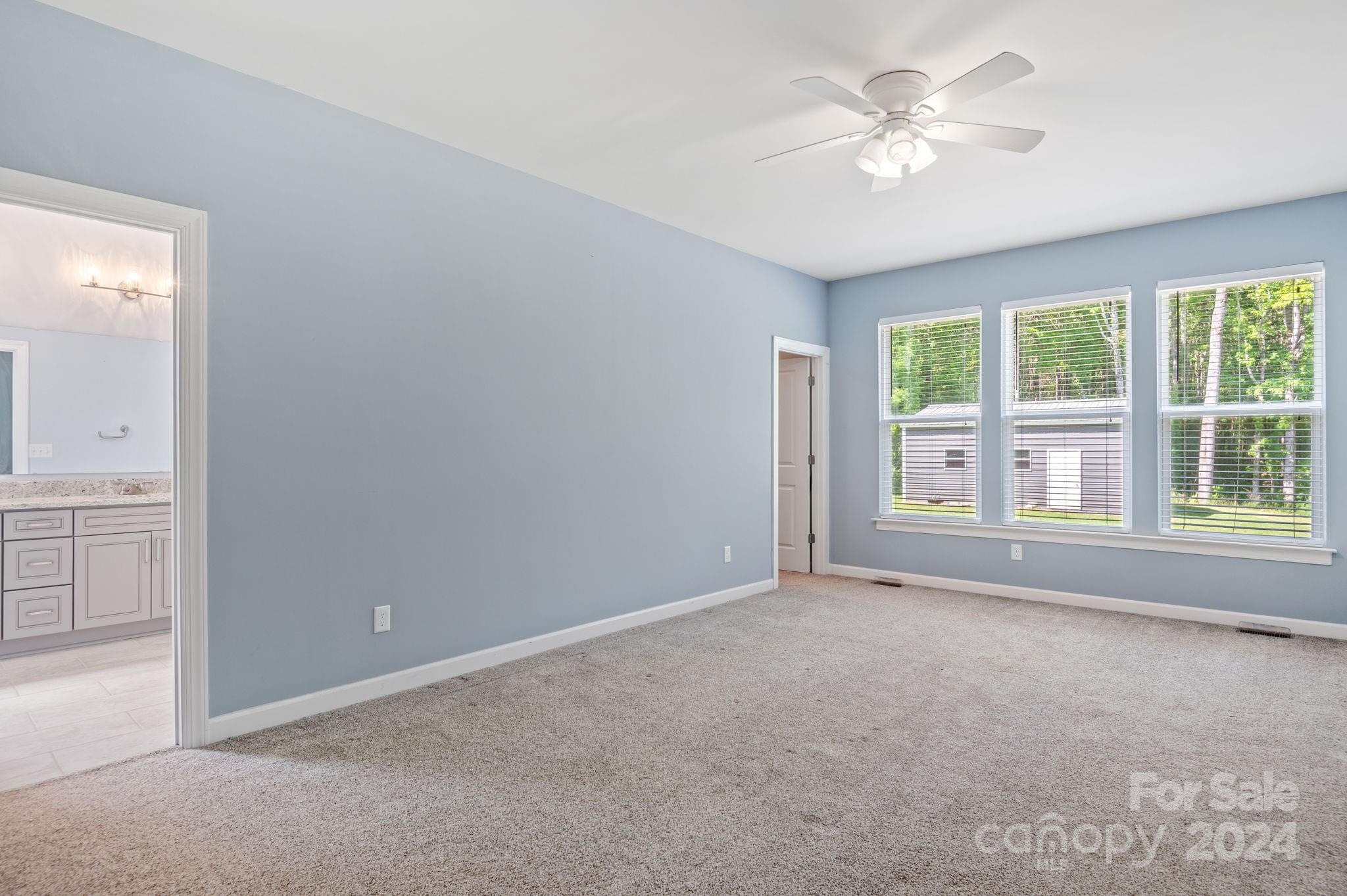 4655 Old Hickory Road Lancaster, SC 29720 - Photo 19 of 35 an empty room with chandelier fan and windows