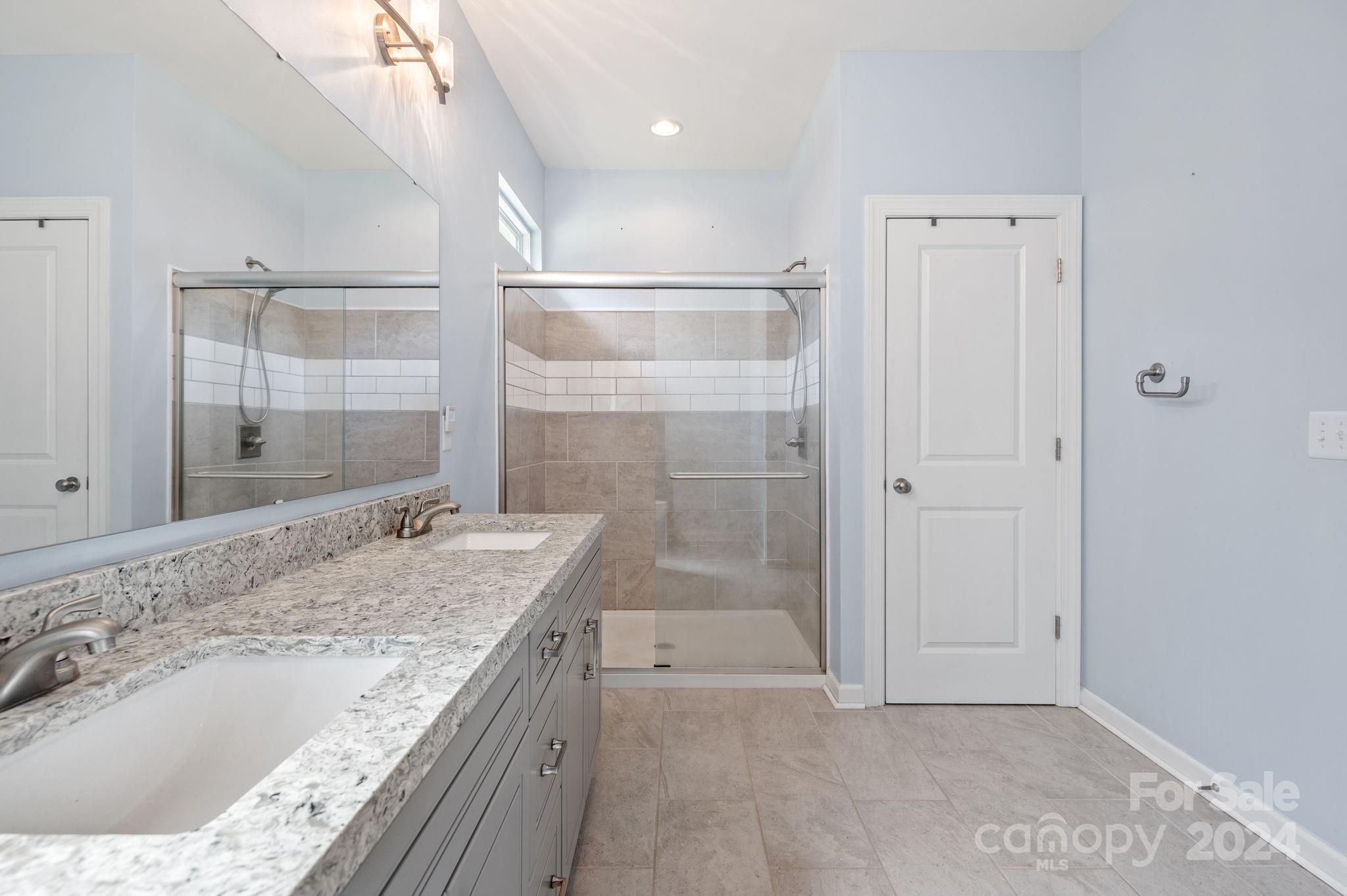 4655 Old Hickory Road Lancaster, SC 29720 - Photo 22 of 35 a bathroom with a granite countertop sink a mirror and shower
