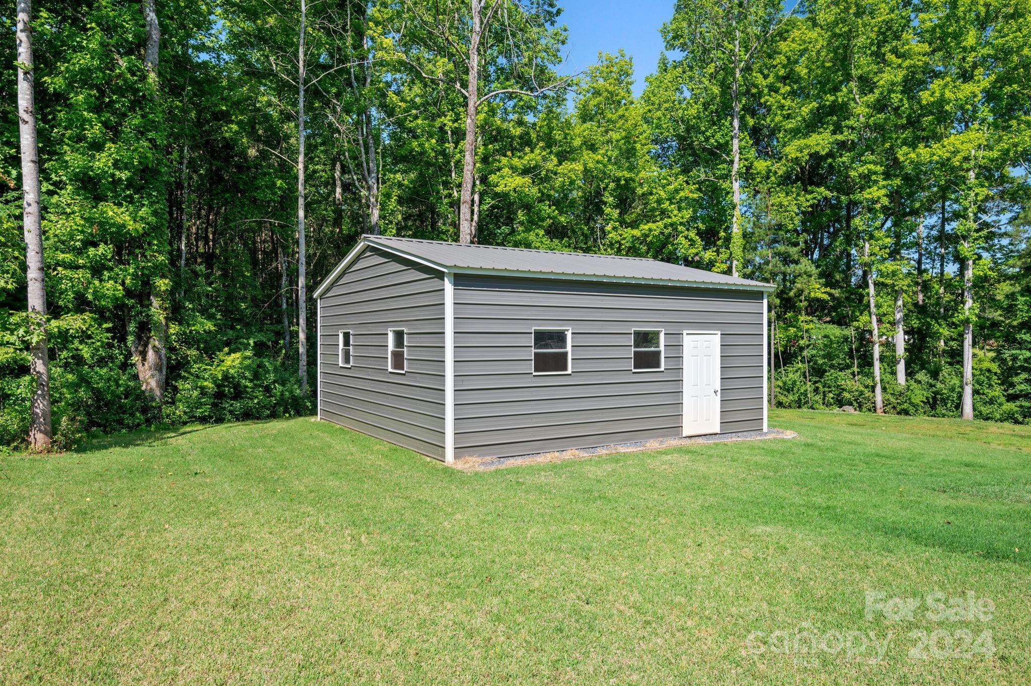4655 Old Hickory Road Lancaster, SC 29720 - Photo 35 of 35 a backyard of a house with plants and large trees