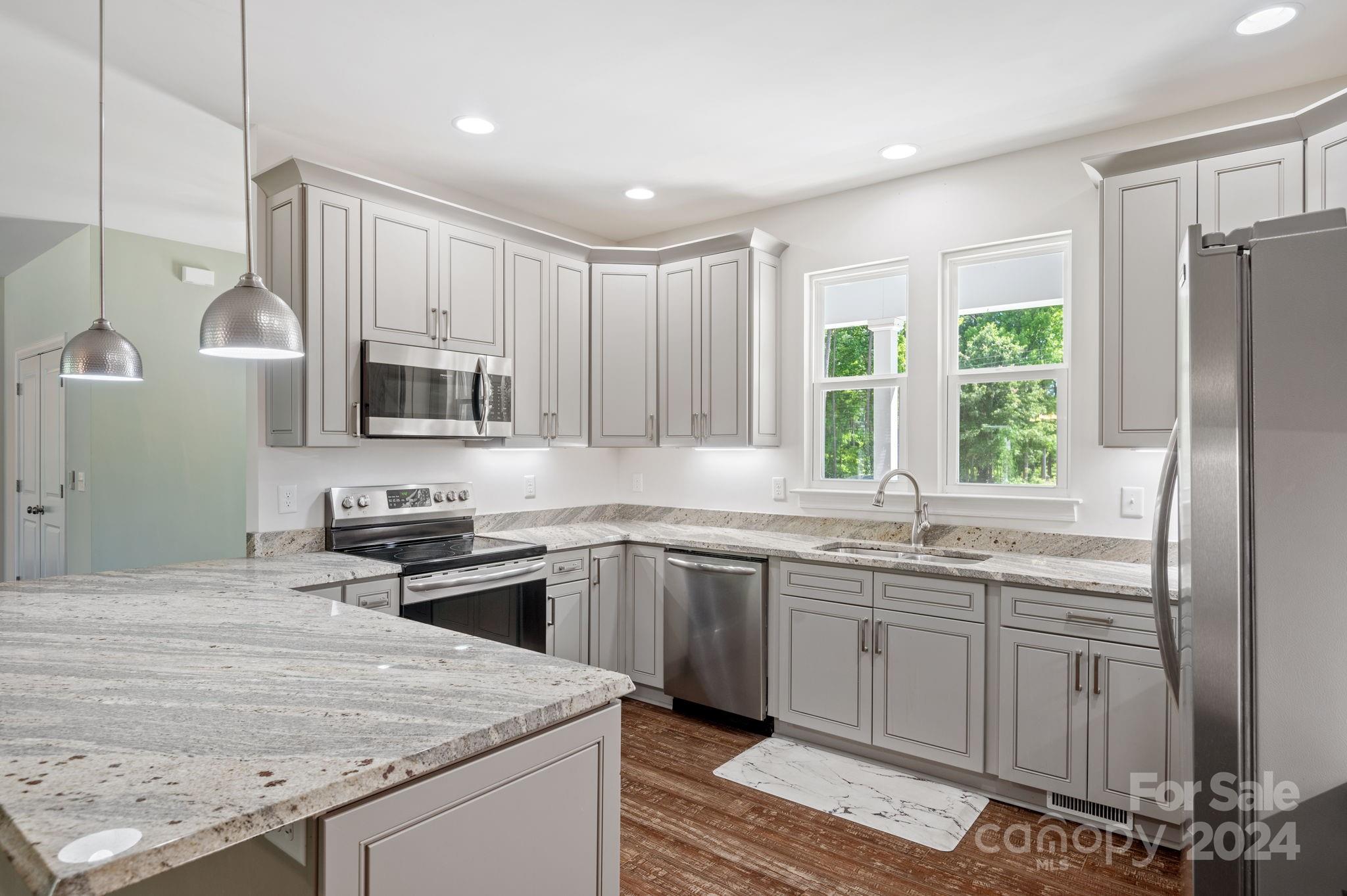 4655 Old Hickory Road Lancaster, SC 29720 - Photo 6 of 35 a kitchen with kitchen island granite countertop a sink stainless steel appliances and cabinets