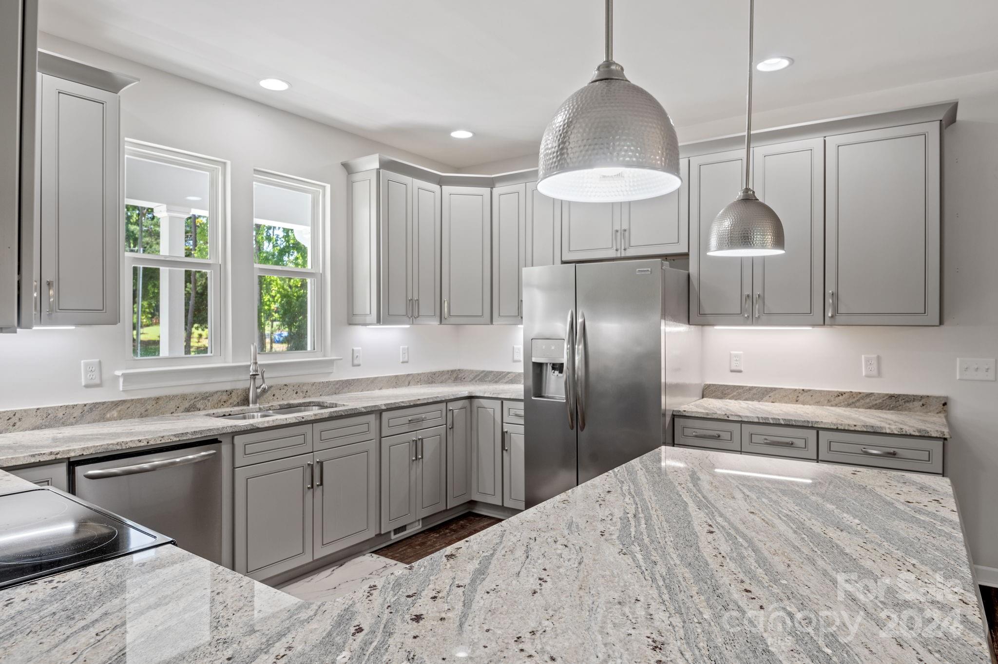 4655 Old Hickory Road Lancaster, SC 29720 - Photo 7 of 35 a kitchen with stainless steel appliances granite countertop a sink a stove and refrigerator