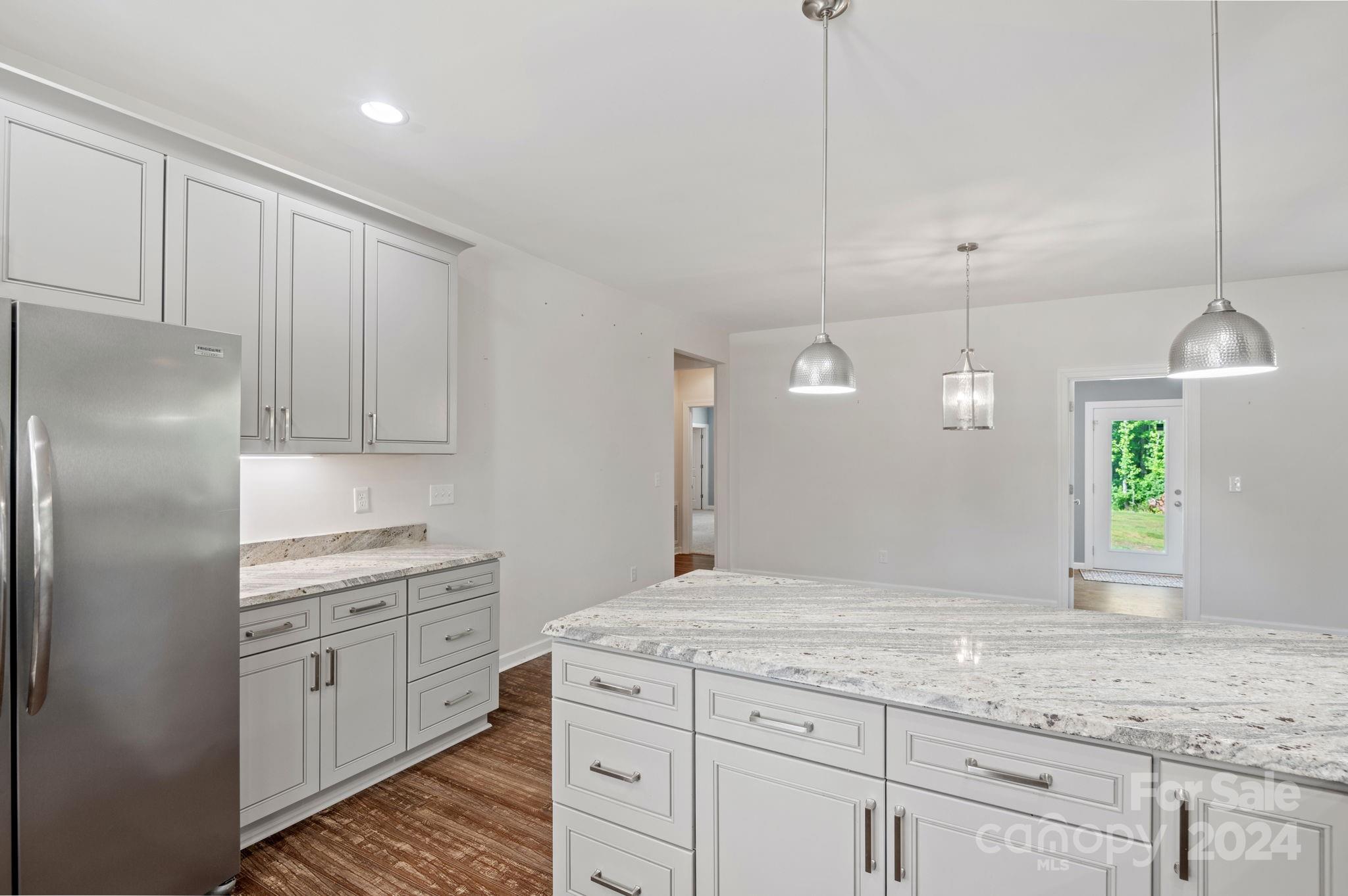 4655 Old Hickory Road Lancaster, SC 29720 - Photo 9 of 35 a kitchen with kitchen island white cabinets and white appliances