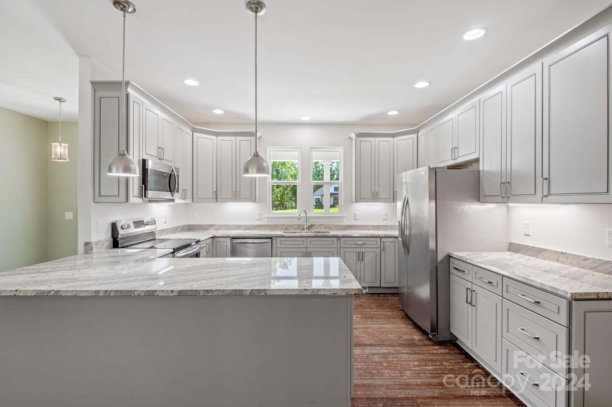 4655 Old Hickory Road Lancaster, SC 29720 - Photo 10 of 35 a kitchen with stainless steel appliances granite countertop a sink a refrigerator and a stove