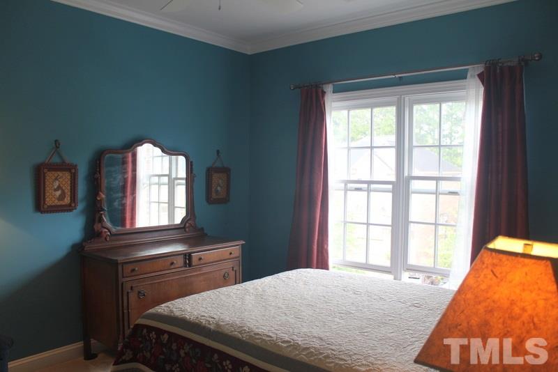 1322 Cameron View Court Raleigh, NC 27607 - Photo 12 of 22 a bedroom with a bed and a dresser next to a window