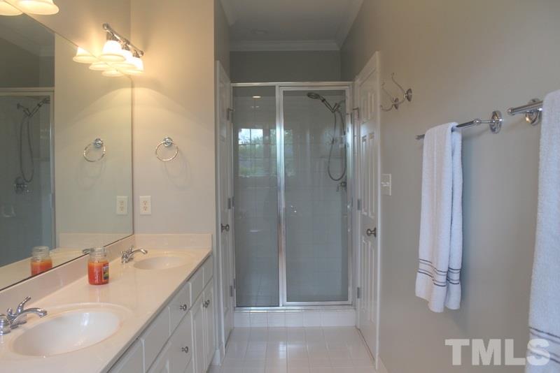 1322 Cameron View Court Raleigh, NC 27607 - Photo 18 of 22 a bathroom with a shower sink vanity and mirror