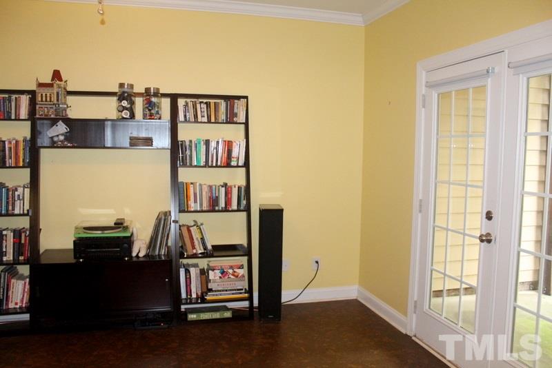 1322 Cameron View Court Raleigh, NC 27607 - Photo 19 of 22 a living room with furniture and a book shelf
