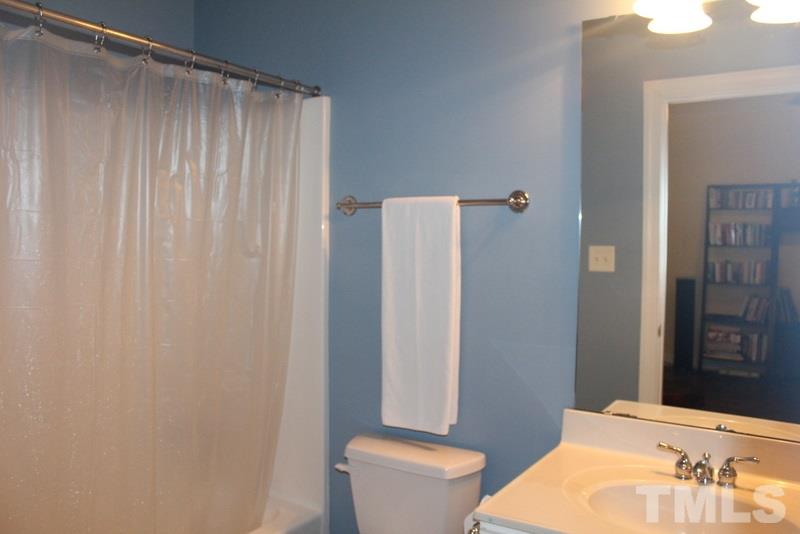 1322 Cameron View Court Raleigh, NC 27607 - Photo 20 of 22 a bathroom with a sink a toilet a mirror and shower curtain