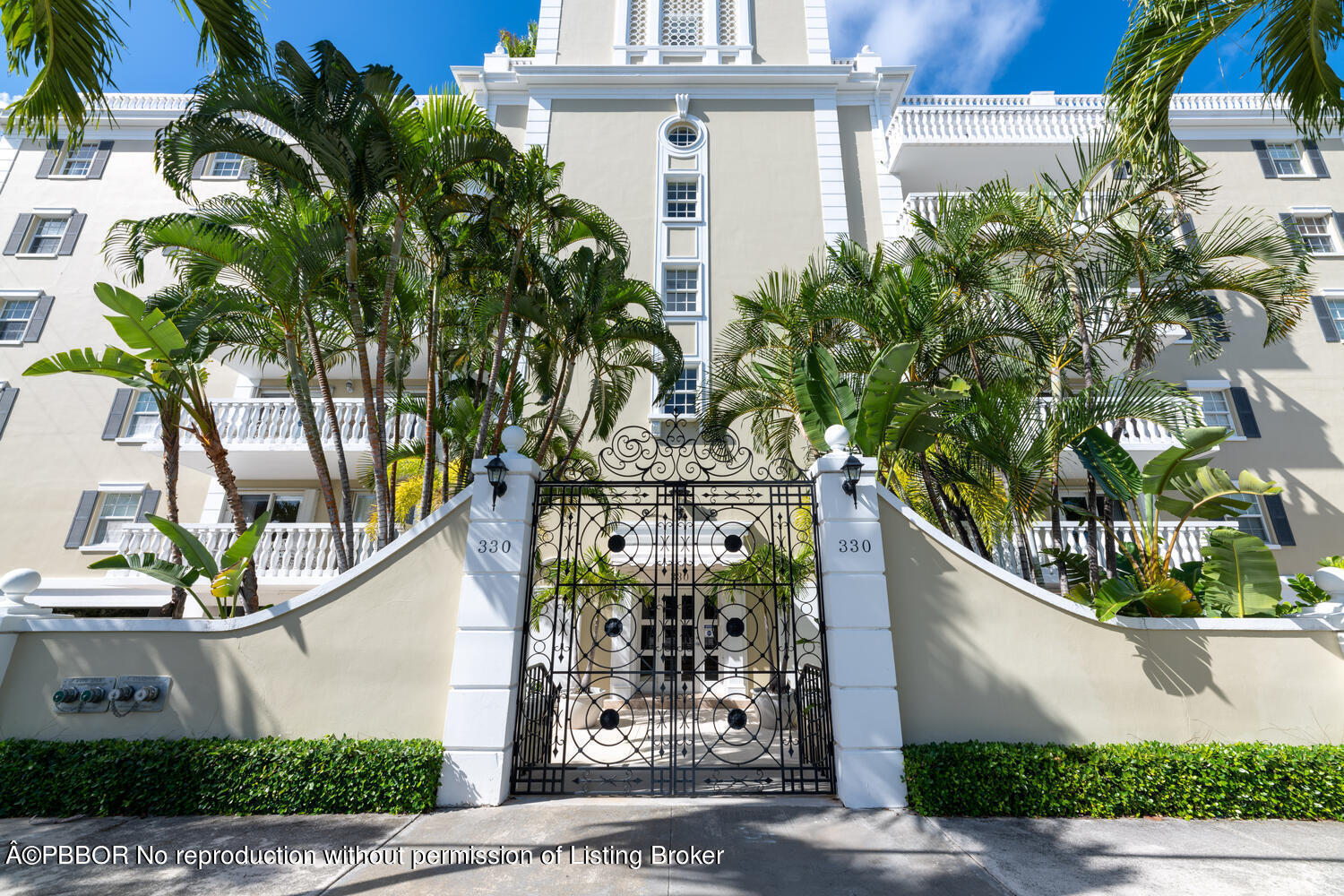 a front view of a house with a tree