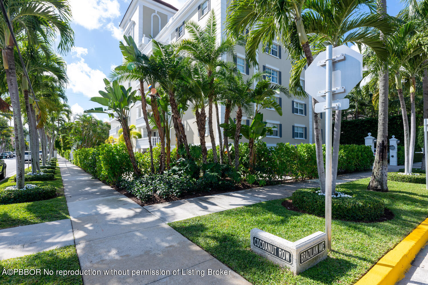 330 Cocoanut Row, Unit 5B Palm Beach, FL 33480 - Photo 28 of 32 a view of a patio with table and chairs potted plants and palm trees