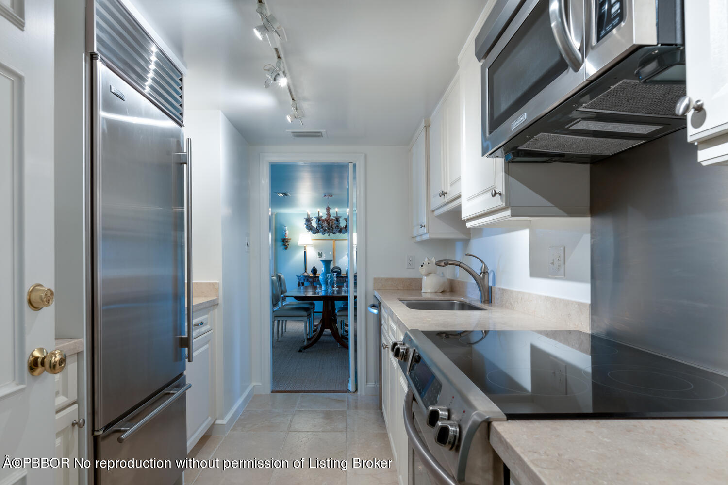 330 Cocoanut Row, Unit 5B Palm Beach, FL 33480 - Photo 7 of 32 a kitchen with stainless steel appliances granite countertop a sink stove and refrigerator