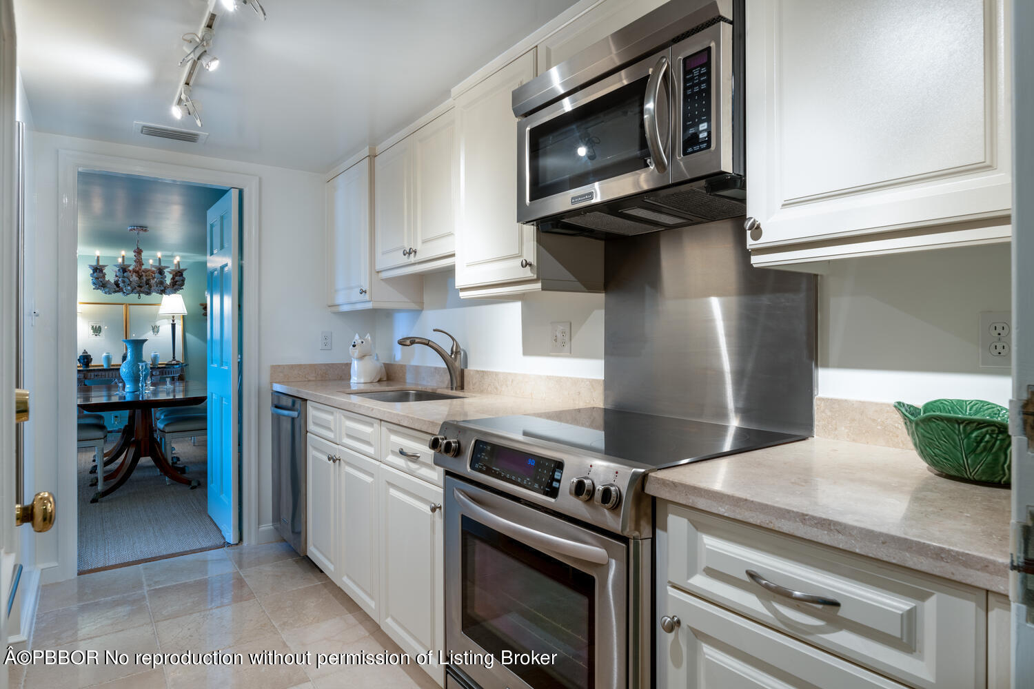 330 Cocoanut Row, Unit 5B Palm Beach, FL 33480 - Photo 8 of 32 a kitchen with stainless steel appliances a stove a microwave and cabinets