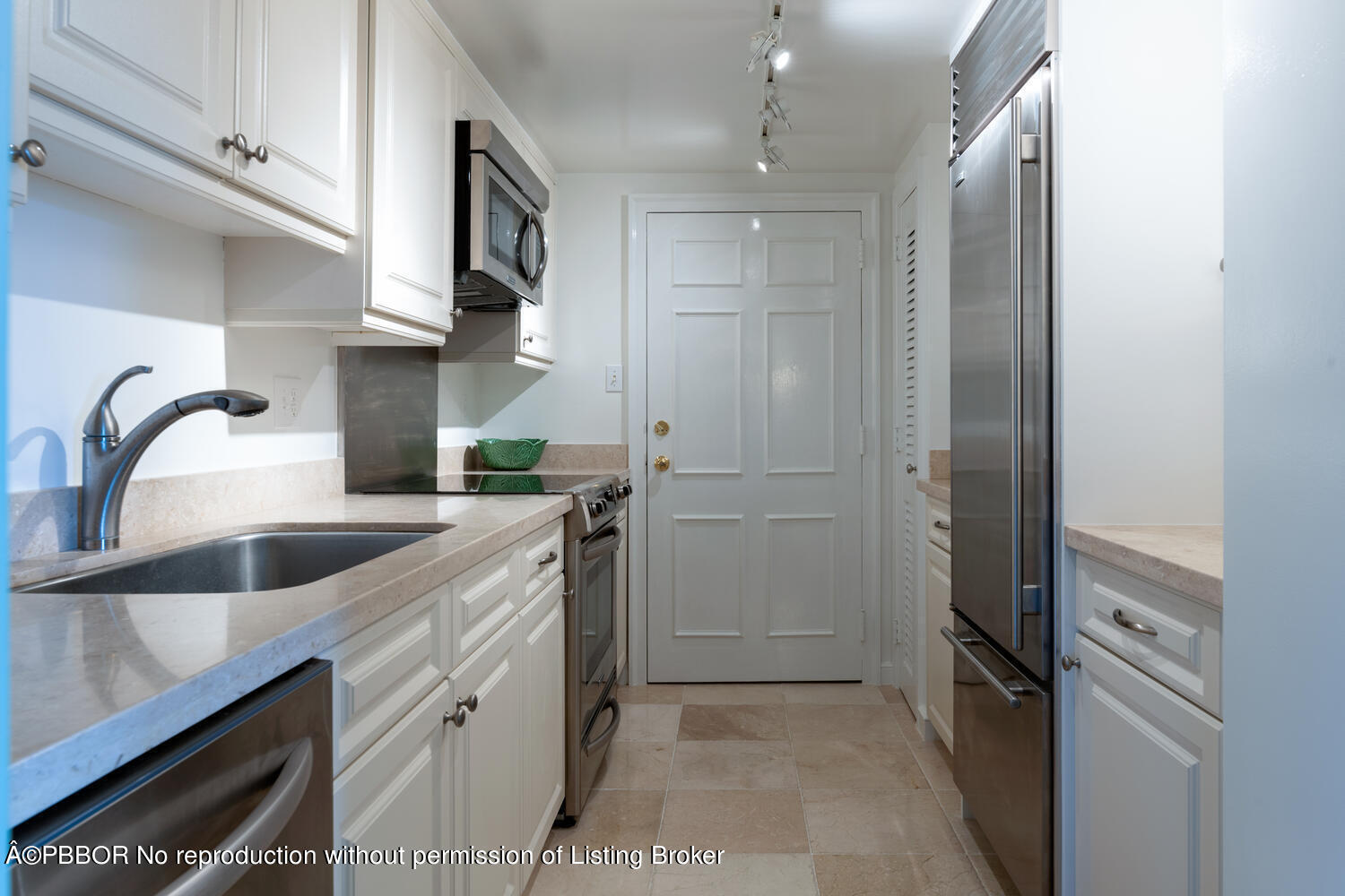 330 Cocoanut Row, Unit 5B Palm Beach, FL 33480 - Photo 9 of 32 a kitchen with a sink and refrigerator