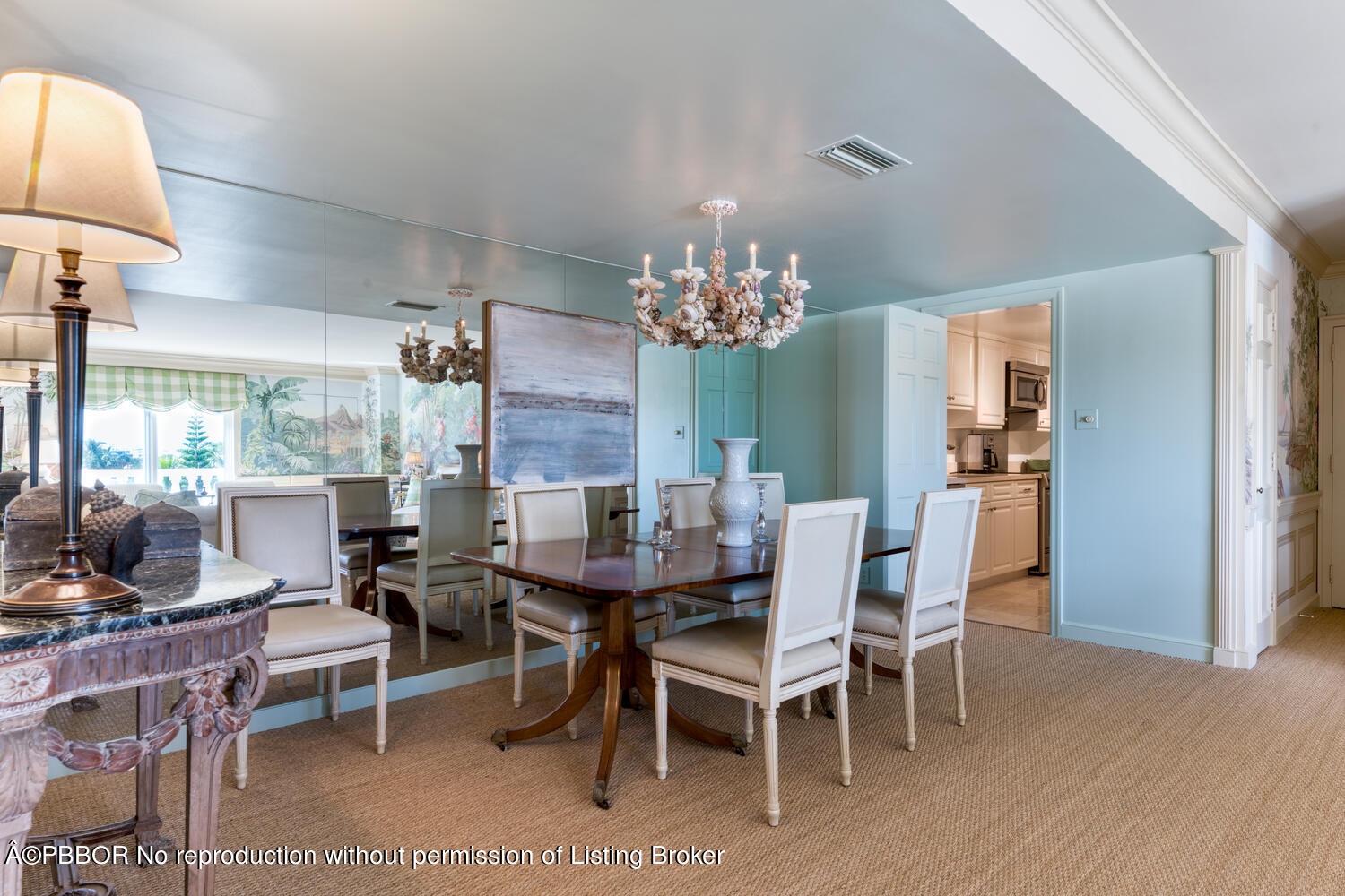 330 Cocoanut Row, Unit 5B Palm Beach, FL 33480 - Photo 10 of 32 a dining room with furniture a chandelier and wooden floor