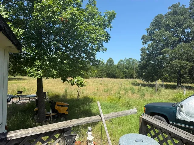 a view of a balcony with two chairs and a stove
