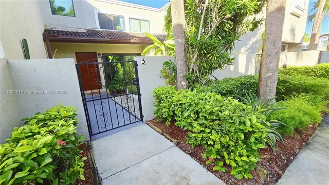 a view of a house with potted plants