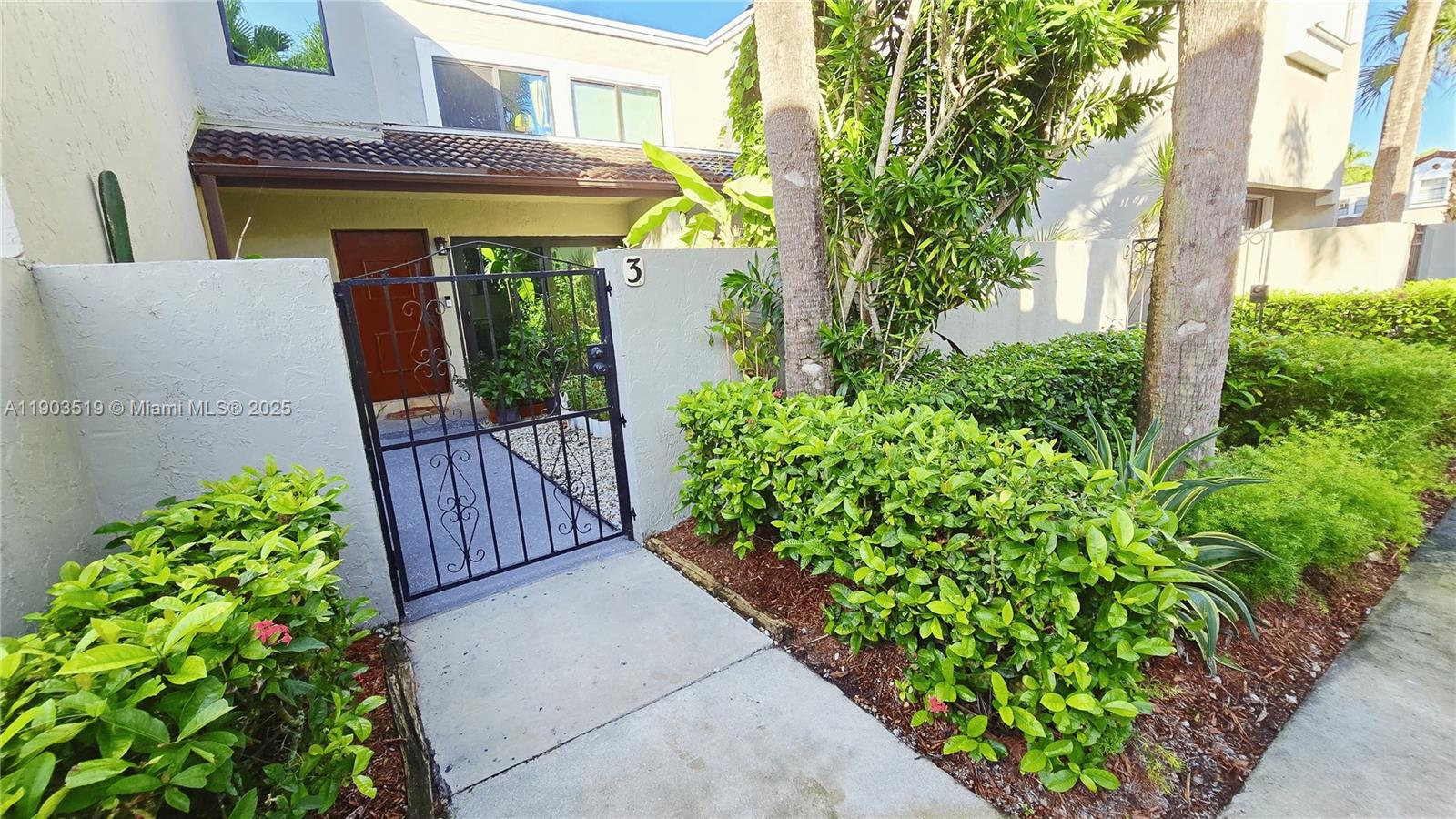 a view of a house with potted plants