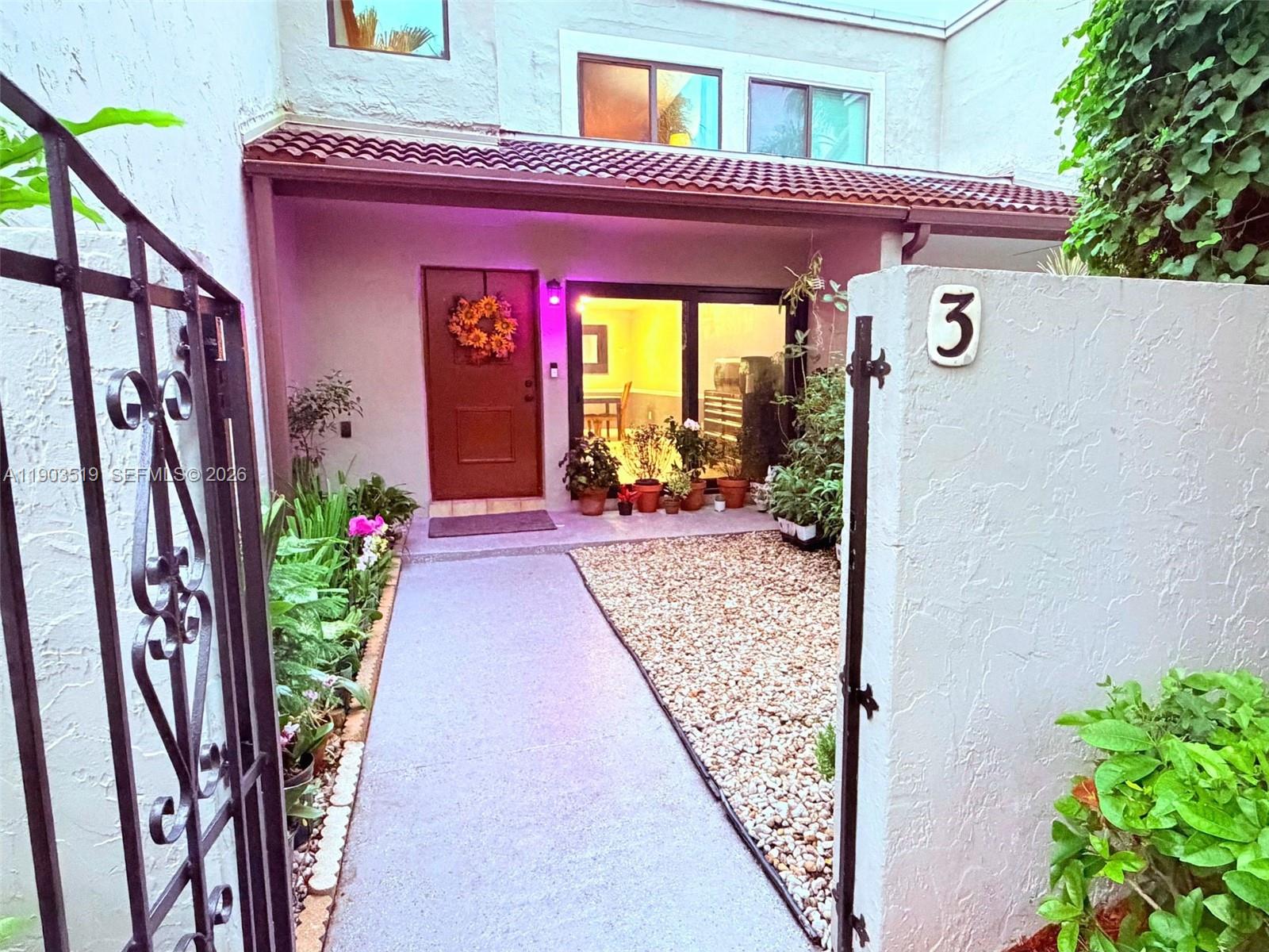 10515 Southwest 153rd Court, Unit 3 Miami, FL 33196 - Photo 1 of 32 a front view of a house with a porch