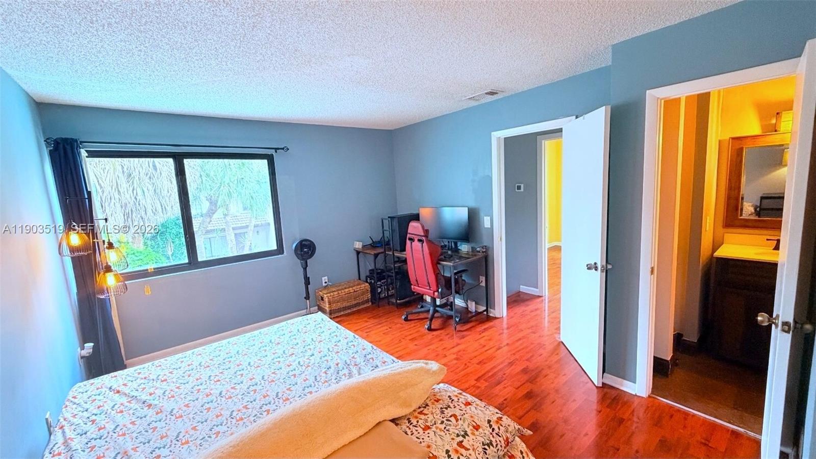 10515 Southwest 153rd Court, Unit 3 Miami, FL 33196 - Photo 17 of 32 a bed room with a bed and a window