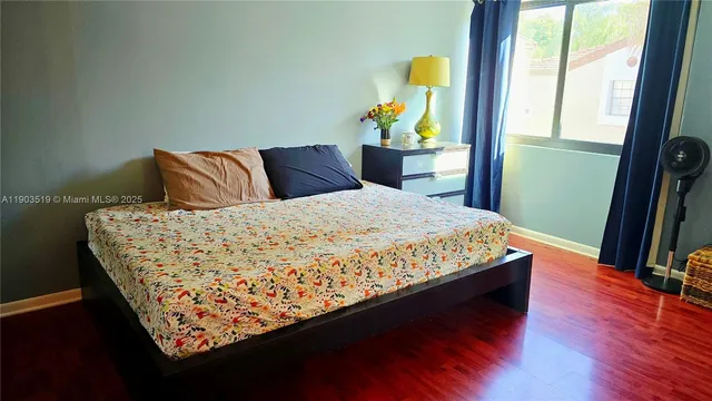 a view of a room with wooden floor and a sink