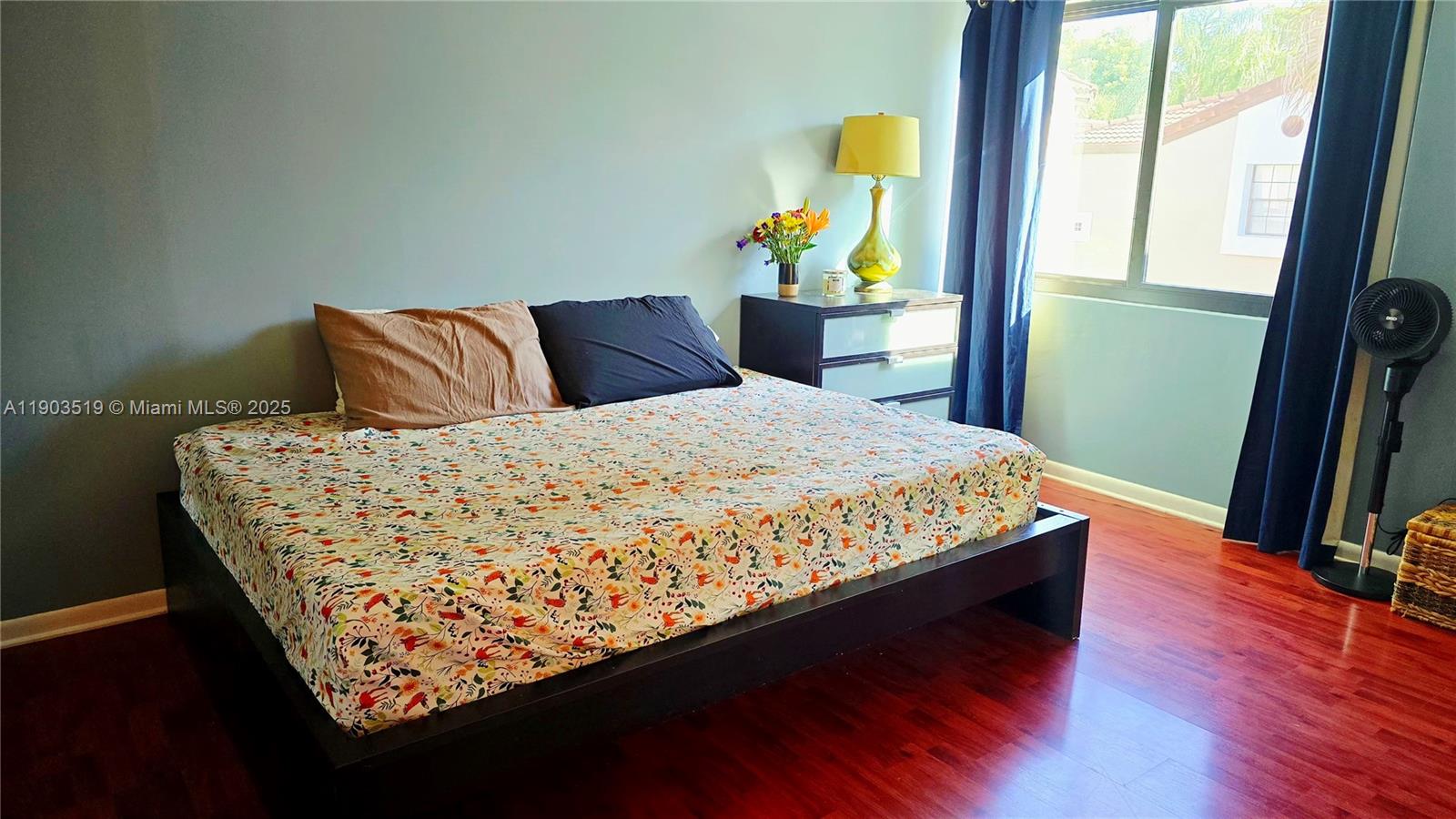 10515 Southwest 153rd Court, Unit 3 Miami, FL 33196 - Photo 17 of 26 a bed sitting in a bedroom next to a window