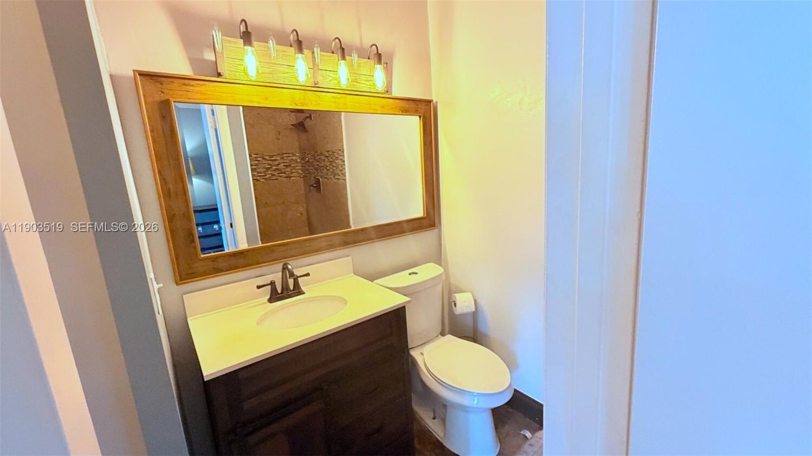 10515 Southwest 153rd Court, Unit 3 Miami, FL 33196 - Photo 18 of 32 a bathroom with a sink and a mirror