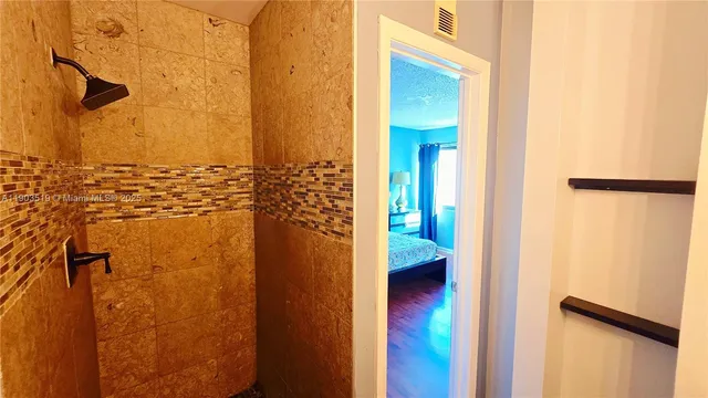 a bedroom with a bed and a dresser next to a window