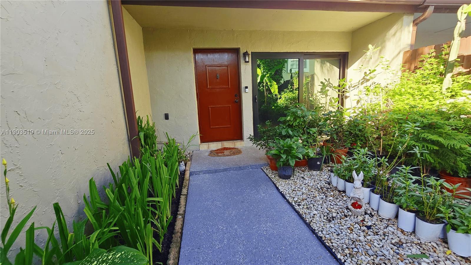 10515 Southwest 153rd Court, Unit 3 Miami, FL 33196 - Photo 2 of 26 a view of a garden with pathway