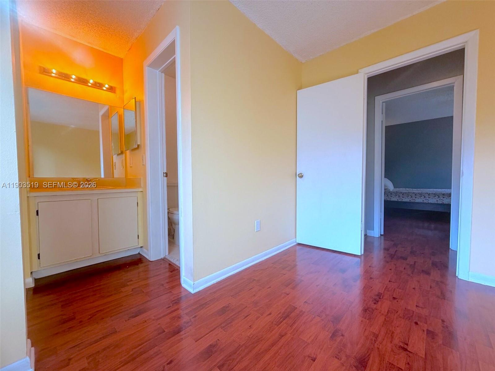 10515 Southwest 153rd Court, Unit 3 Miami, FL 33196 - Photo 23 of 32 a view of a hallway with wooden floor