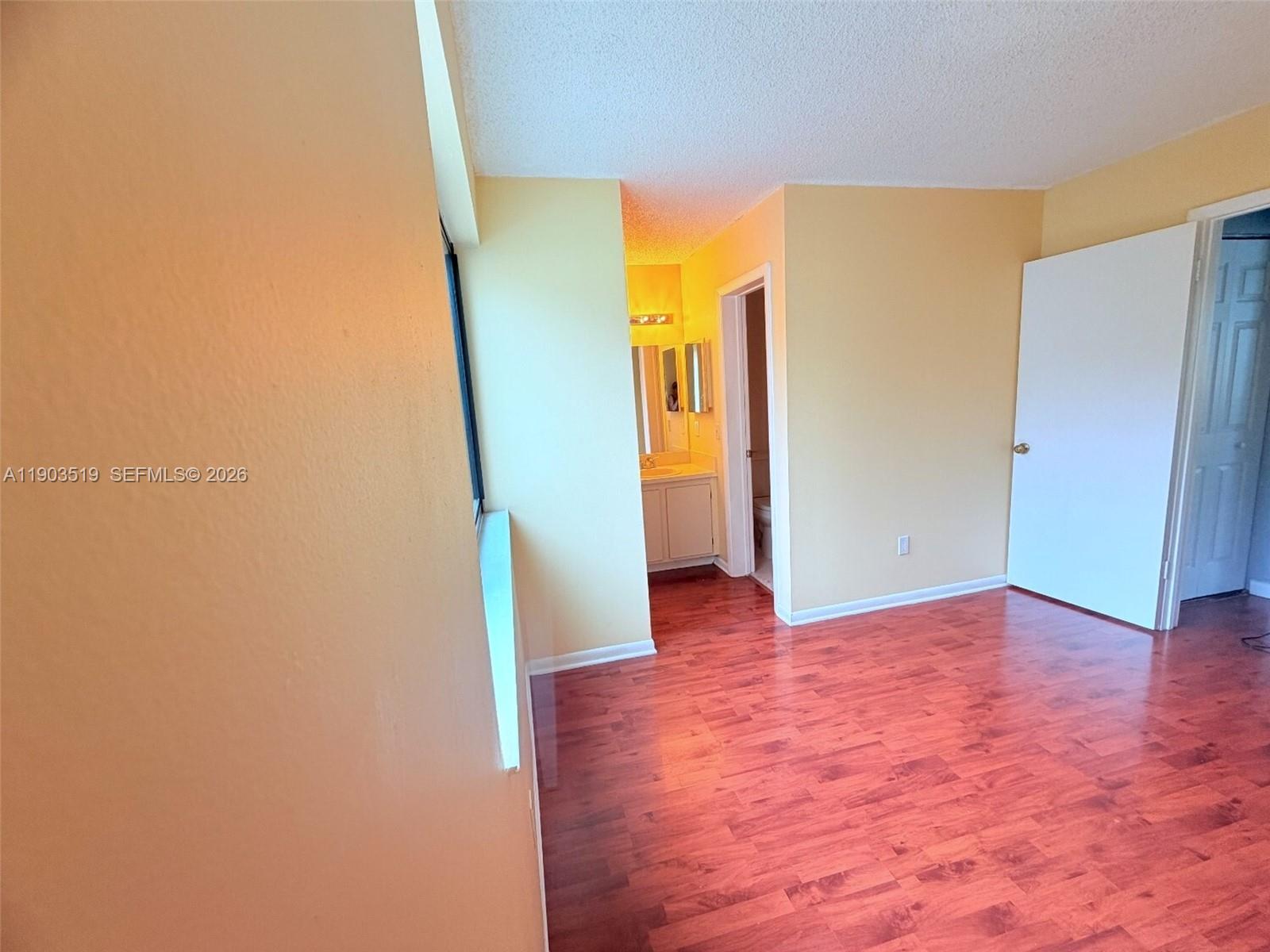 10515 Southwest 153rd Court, Unit 3 Miami, FL 33196 - Photo 25 of 32 a view of a hallway with wooden floor