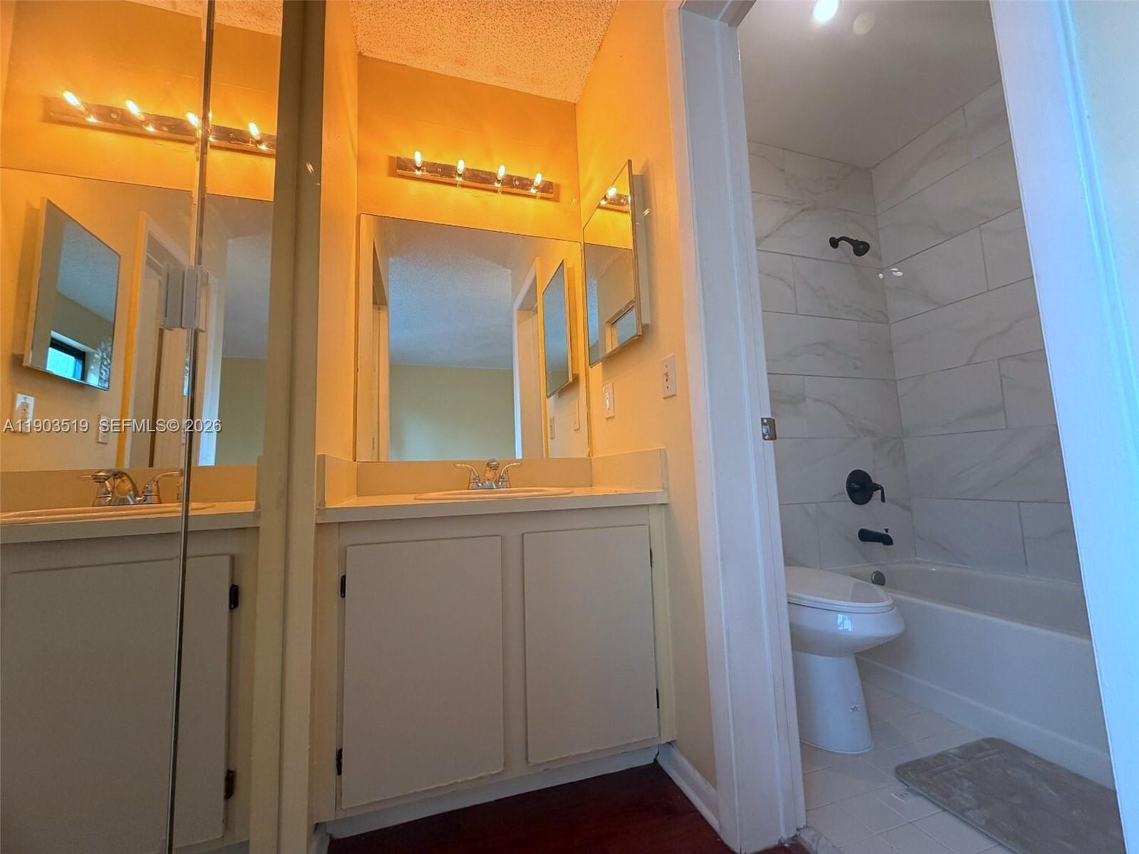 10515 Southwest 153rd Court, Unit 3 Miami, FL 33196 - Photo 27 of 32 a bathroom with a toilet sink and shower