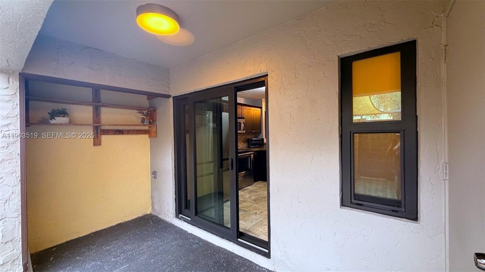 10515 Southwest 153rd Court, Unit 3 Miami, FL 33196 - Photo 28 of 32 a view of an empty room with a window