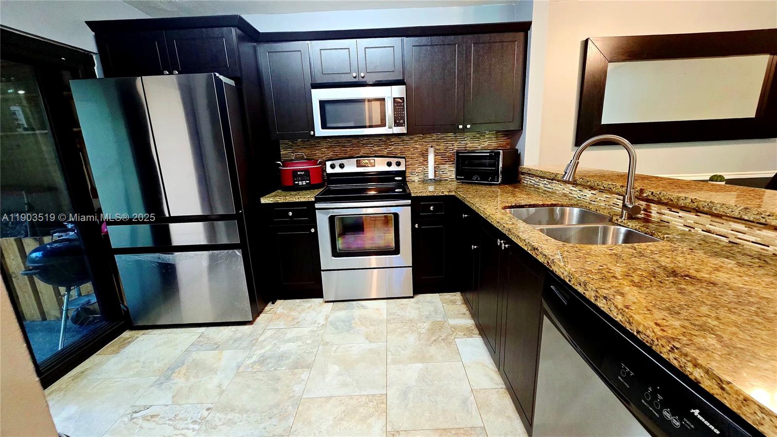 10515 Southwest 153rd Court, Unit 3 Miami, FL 33196 - Photo 6 of 26 a kitchen with stainless steel appliances granite countertop a sink stove and refrigerator