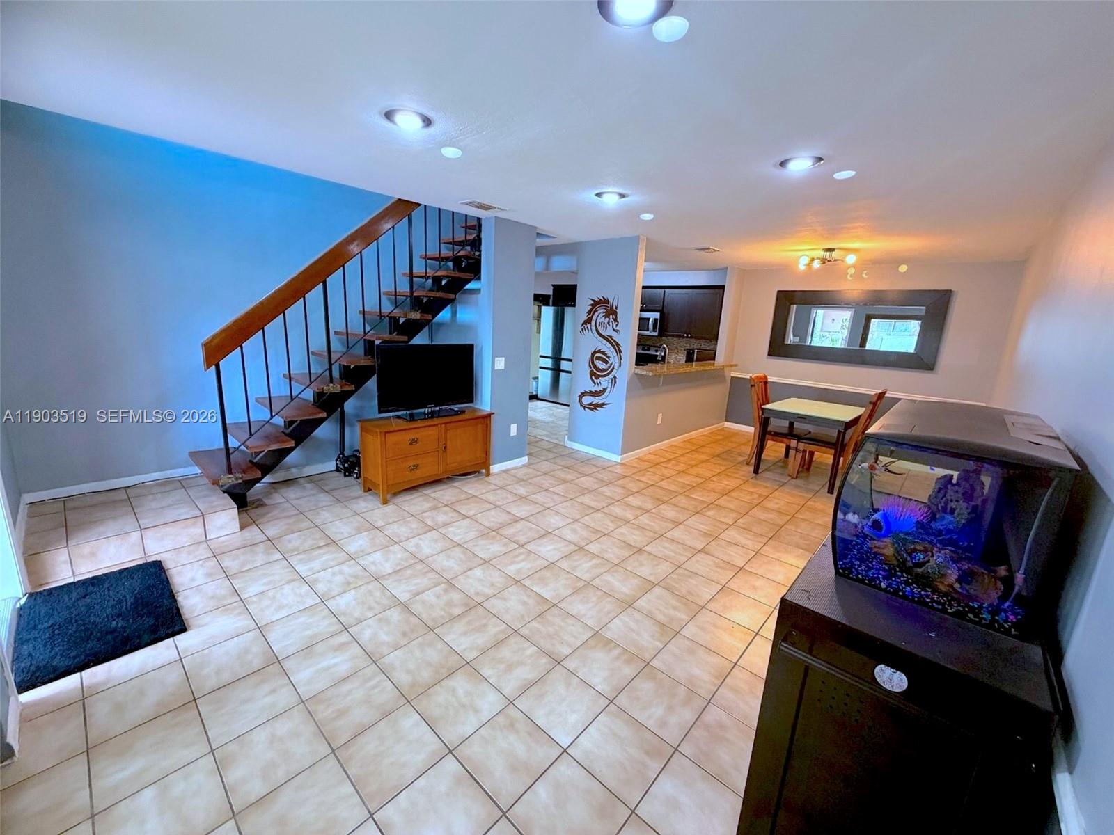 10515 Southwest 153rd Court, Unit 3 Miami, FL 33196 - Photo 7 of 32 a living room with furniture and a flat screen tv
