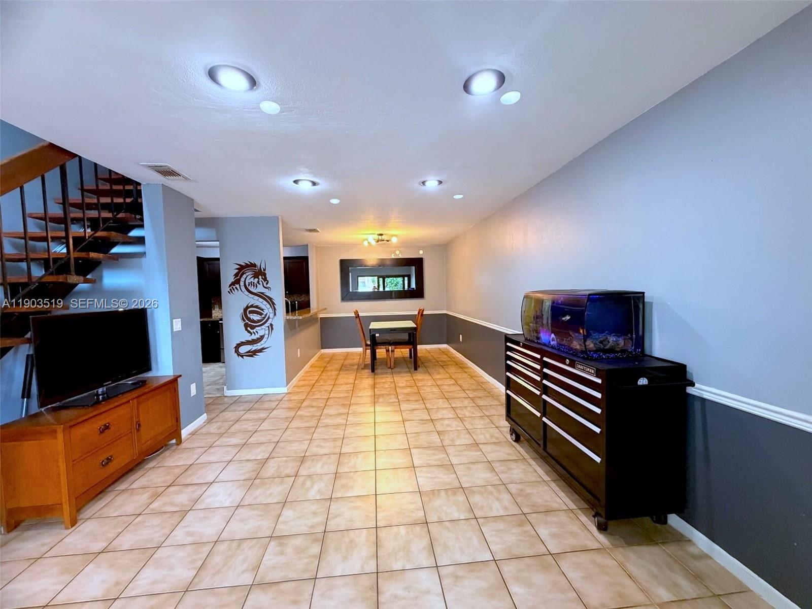 10515 Southwest 153rd Court, Unit 3 Miami, FL 33196 - Photo 8 of 32 a room with furniture a flat screen tv and glass door