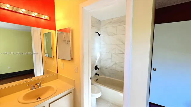 a bathroom with a sink toilet and mirror