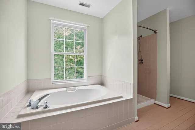 a white bath tub sitting next to a window
