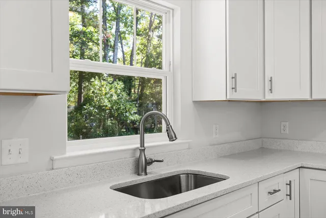 a kitchen with a sink and cabinets