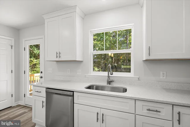 a kitchen with a sink and cabinets