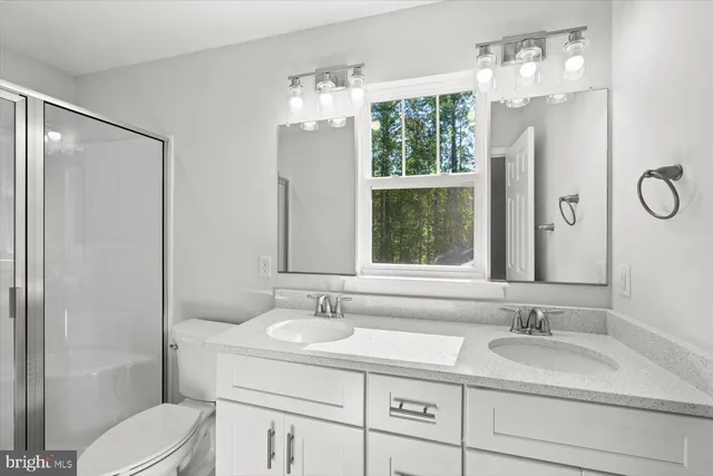 a bathroom with a sink double vanity and a mirror