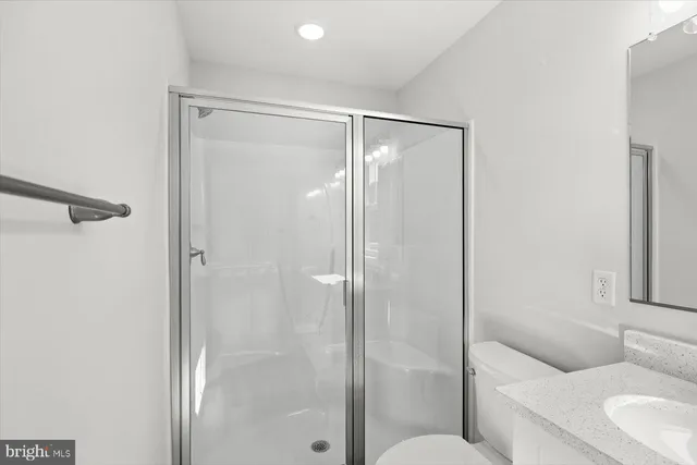 a bathroom with a shower a toilet and a sink