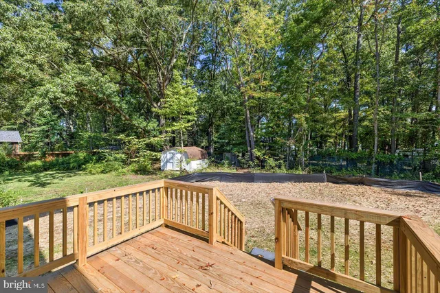 a view of wooden deck and a yard with swimming pool