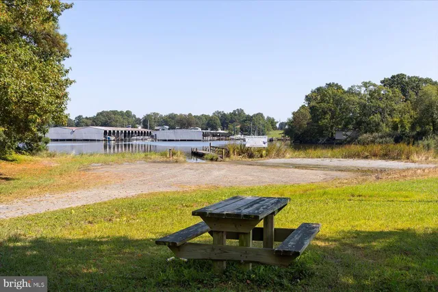 a view of a lake with a table and chairs