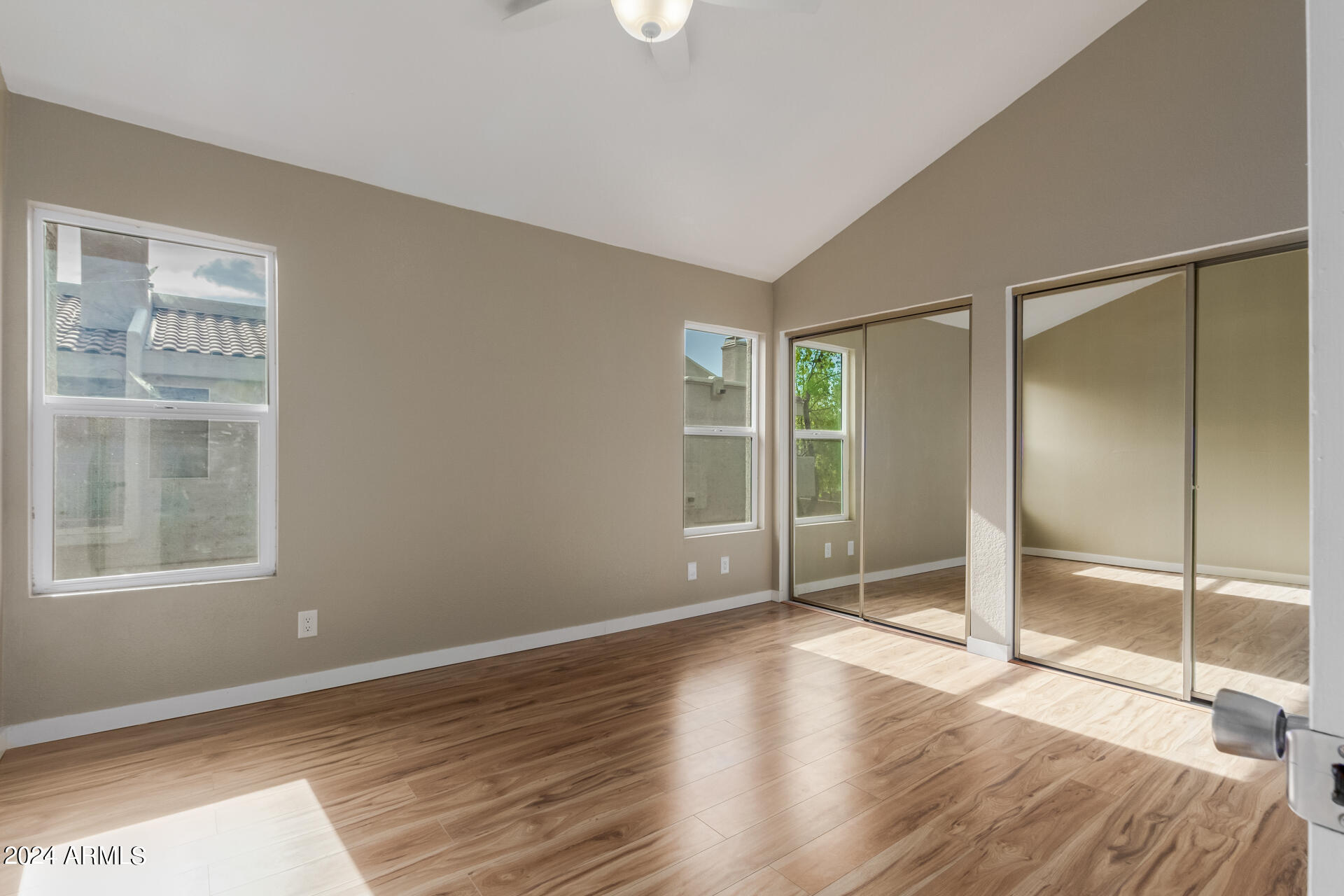 2834 South Ext Road, Unit 2058 Mesa, AZ 85210 - Photo 18 of 33 a view of an empty room with wooden floor and a window