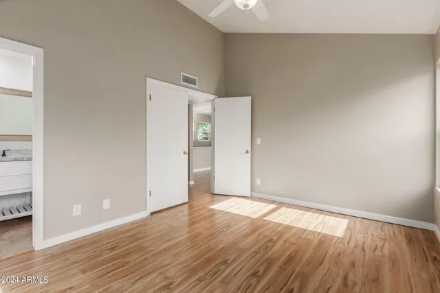 a view of an empty room with wooden floor