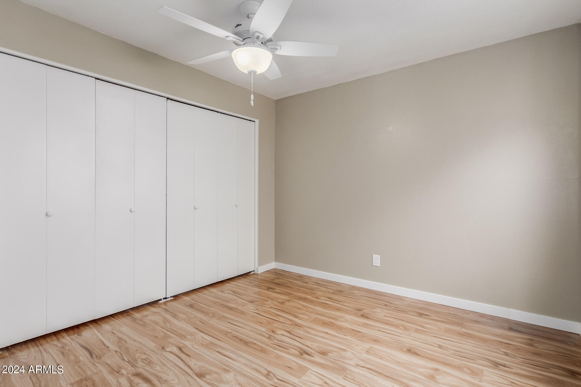 2834 South Ext Road, Unit 2058 Mesa, AZ 85210 - Photo 23 of 33 a view of an empty room with wooden floor