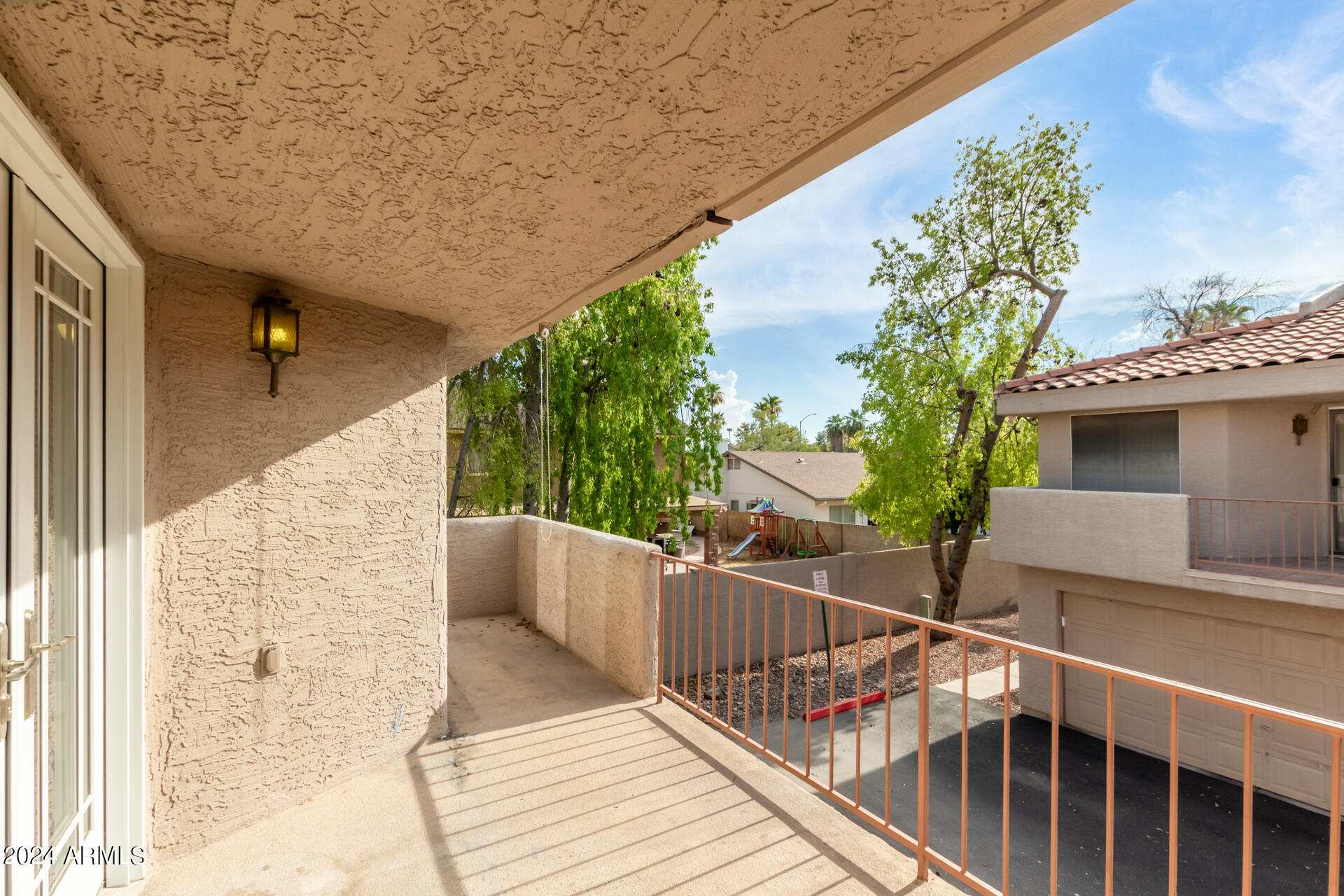2834 South Ext Road, Unit 2058 Mesa, AZ 85210 - Photo 29 of 33 a view of a balcony with wooden floor and fence