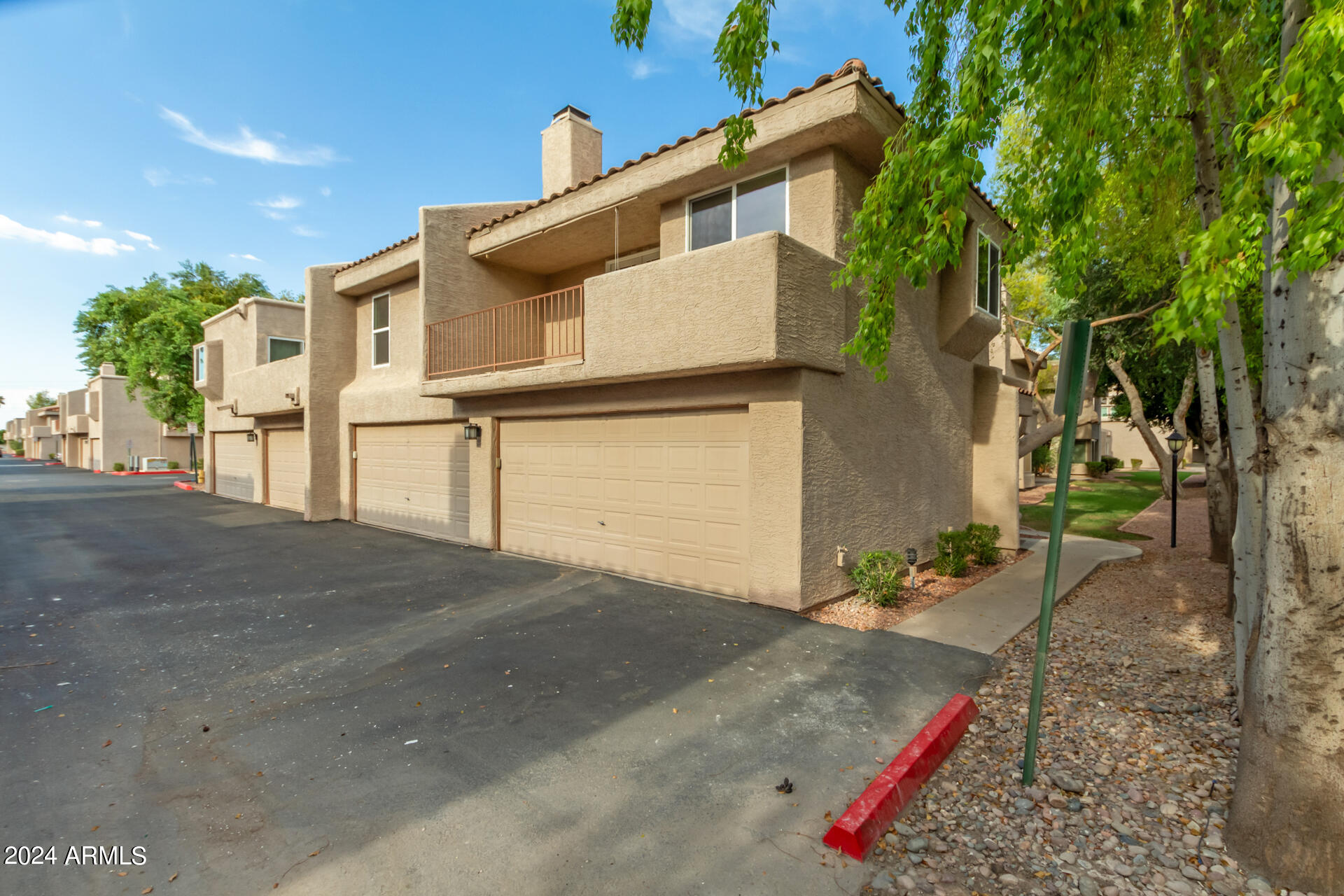 2834 South Ext Road, Unit 2058 Mesa, AZ 85210 - Photo 3 of 33 a front view of a house with a yard and garage